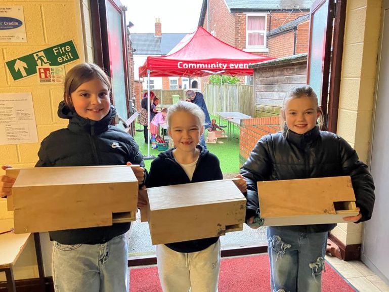 Children holding swift boxes they have made