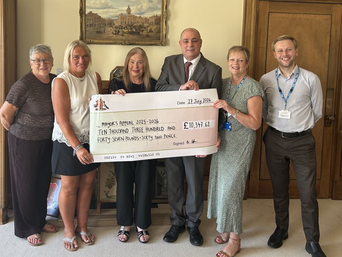 Cllr Barry Dyke and Marie Dyke presenting a cheque to their chosen charities
